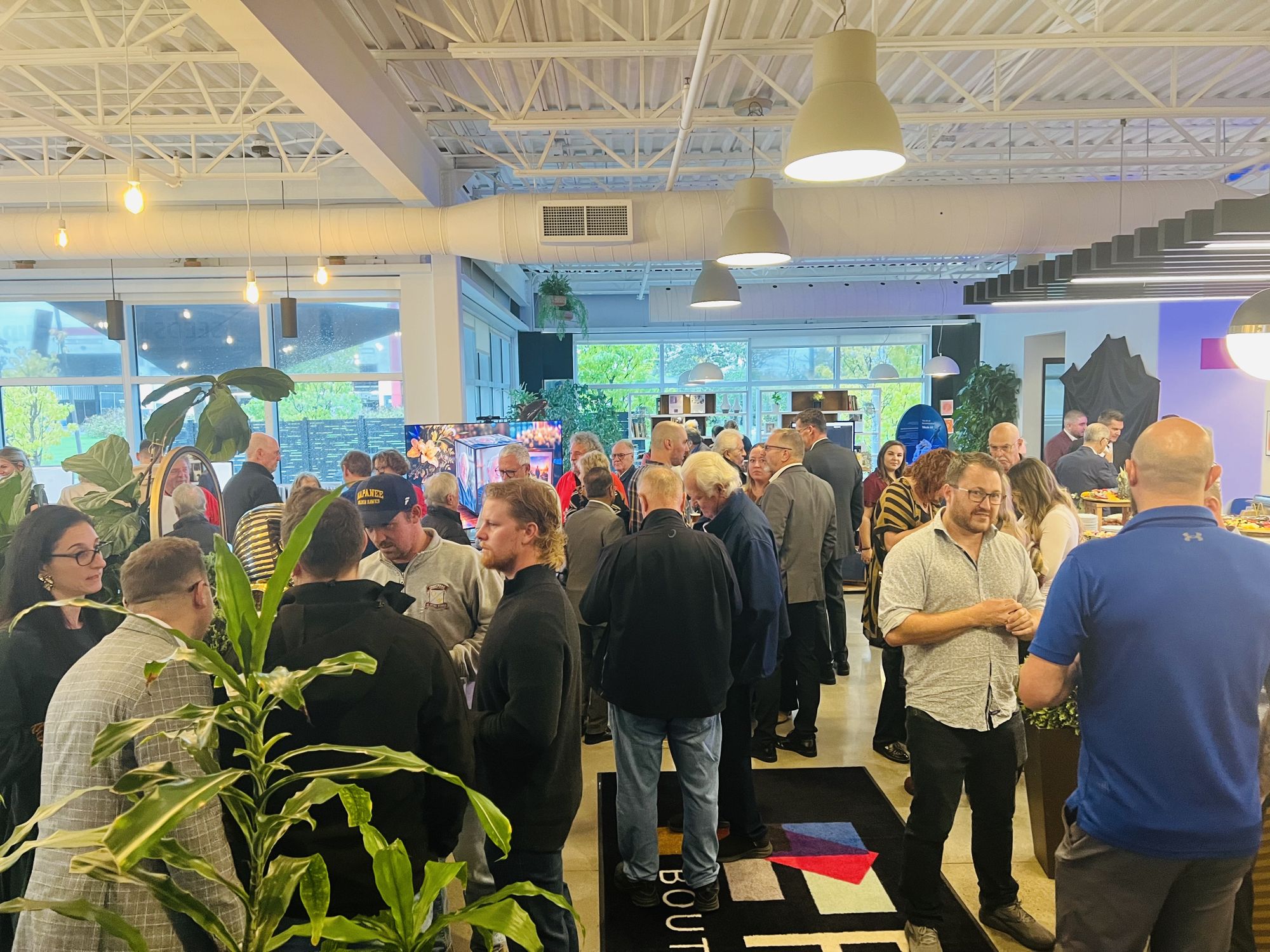 A full room of guests talking during the Kingston Preview evening
